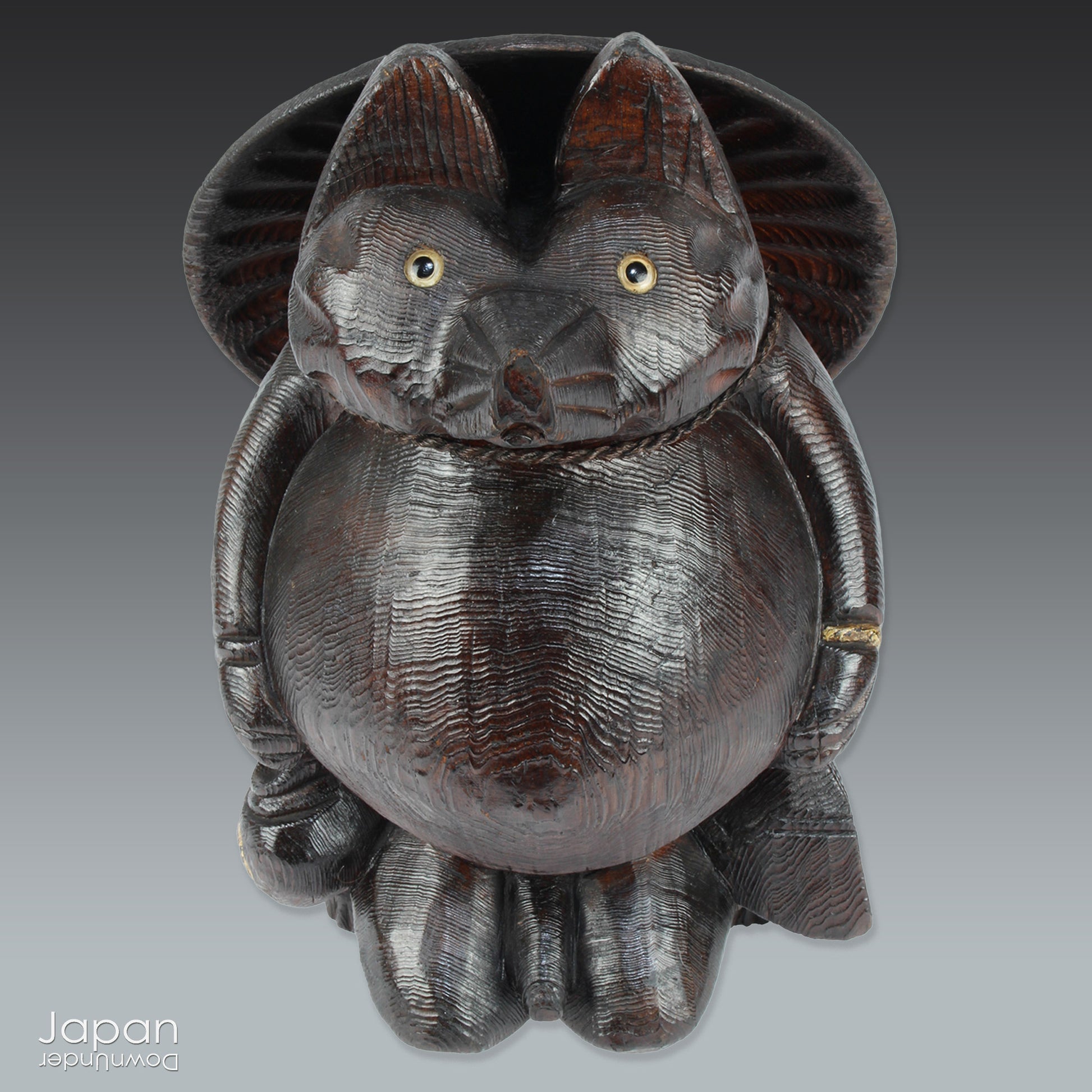 Bring home a delightful piece of traditional Japanese folk art with this exceptionally rare and impressively large antique wooden tanuki -  a beloved symbol of good luck, prosperity, and playful mischief in Japanese culture.