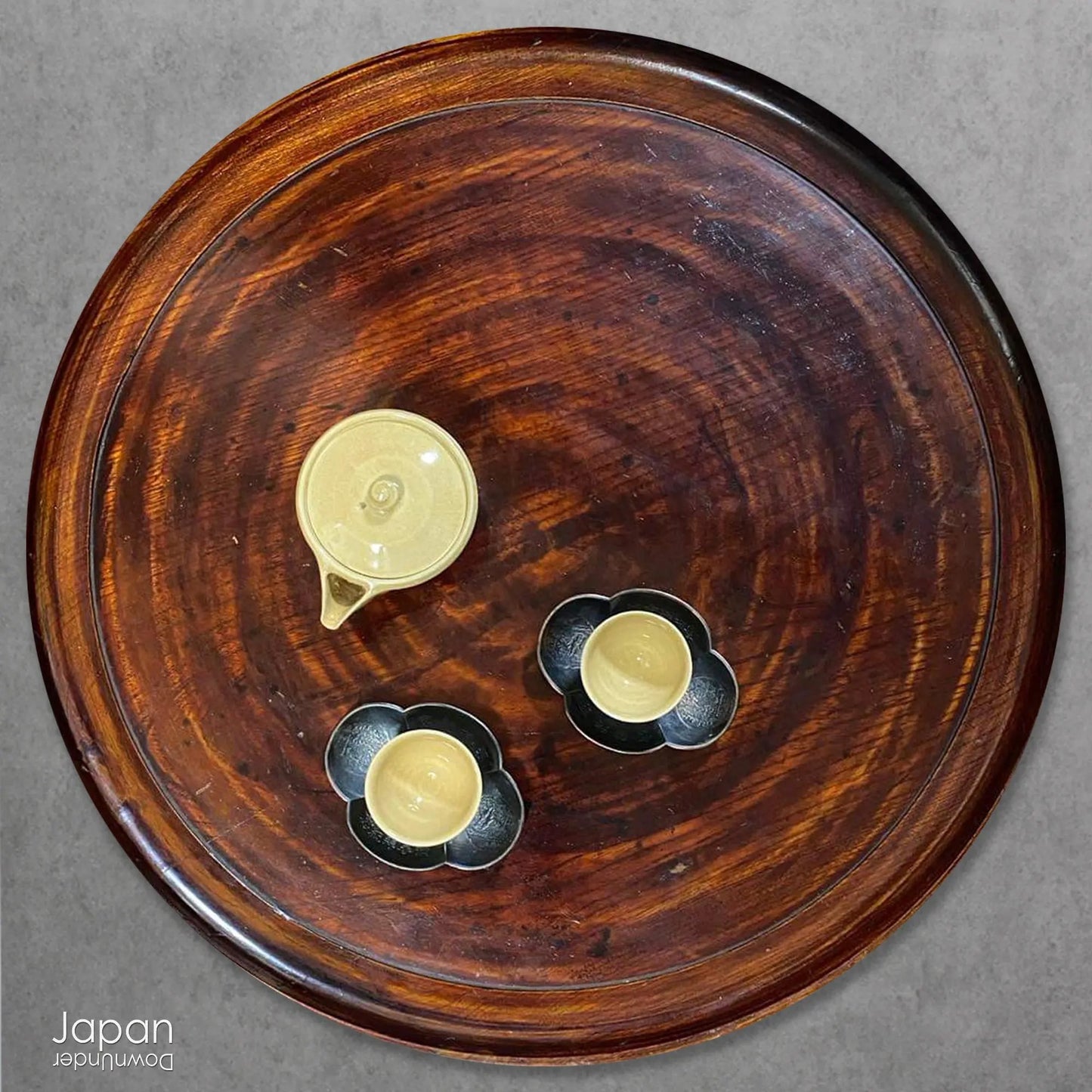 Add timeless charm and rustic elegance to your home with this exceptionally large antique round tea tray, hand-carved from a single cross-section of zelkova (keyaki) wood. A beautiful marriage of form and function, this piece serves equally well as a statement display stand, a unique tabletop, or a traditional tea-serving tray.