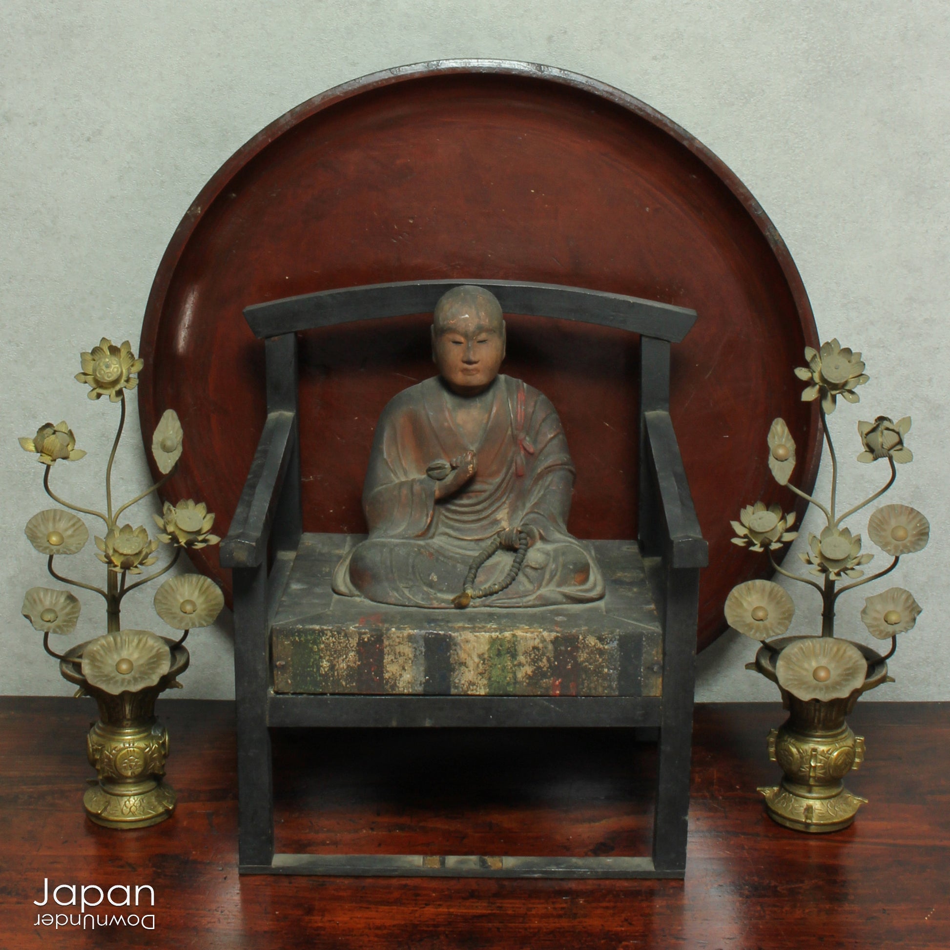 A stunning 1800’s Japanese folk art round serving tray. This versatile piece doubles as a unique display stand adding a touch of rustic charm to any decor. The beautiful dark wine red and black color palette showcases the wonderful patina of use, making it a truly one-of-a-kind art object.