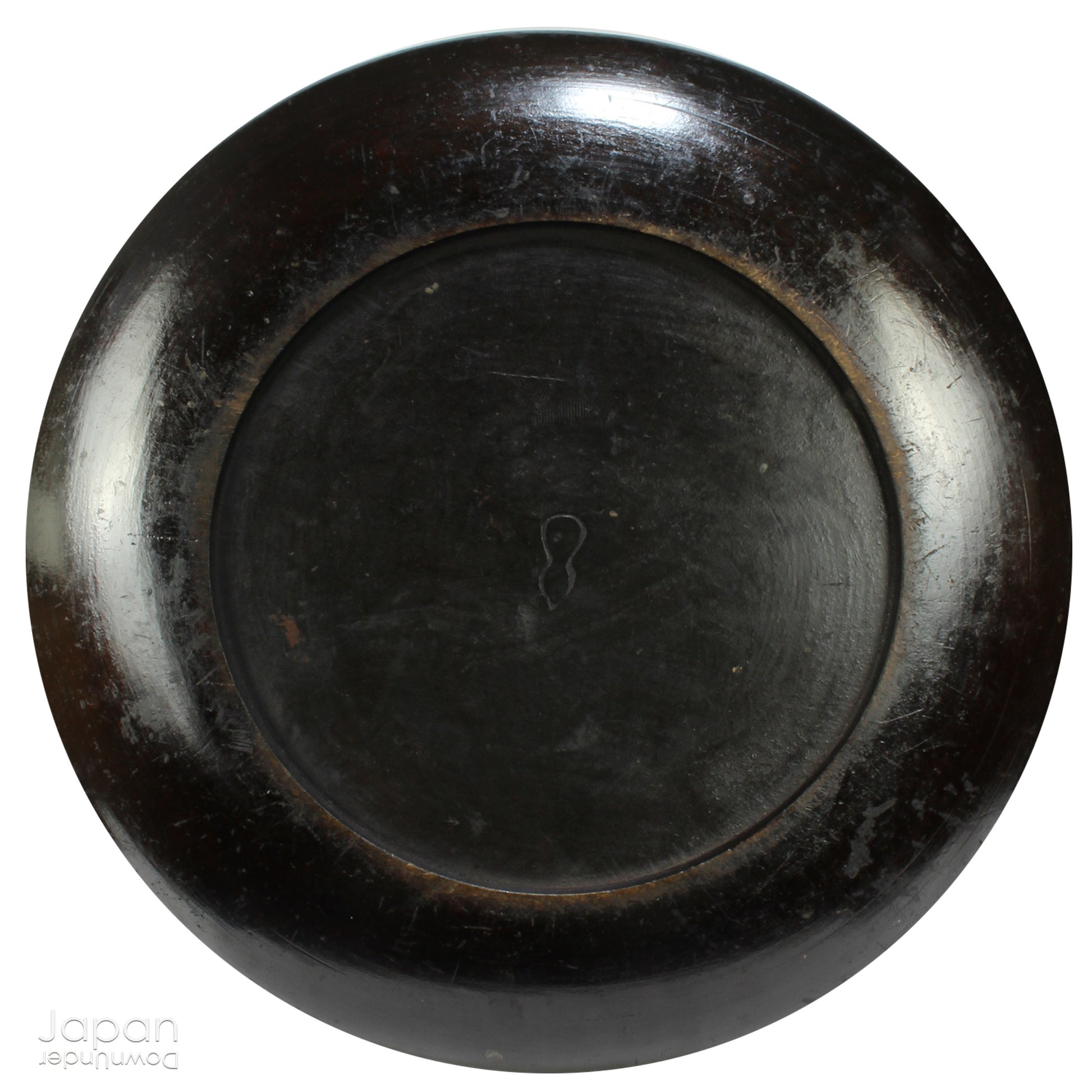 A stunning 1800’s Japanese folk art round serving tray. This versatile piece doubles as a unique display stand adding a touch of rustic charm to any decor. The beautiful dark wine red and black color palette showcases the wonderful patina of use, making it a truly one-of-a-kind art object.