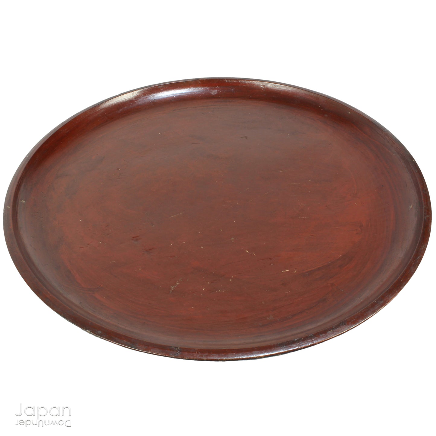 A stunning 1800’s Japanese folk art round serving tray. This versatile piece doubles as a unique display stand adding a touch of rustic charm to any decor. The beautiful dark wine red and black color palette showcases the wonderful patina of use, making it a truly one-of-a-kind art object.