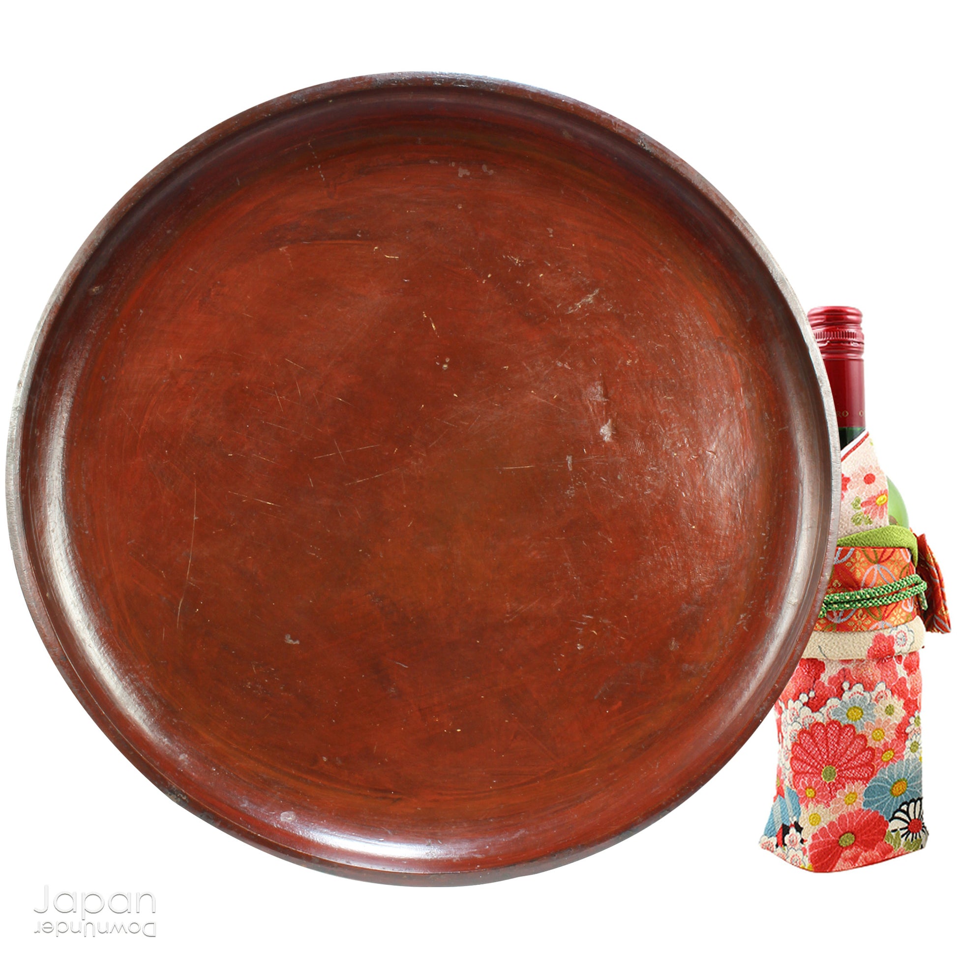 A stunning 1800’s Japanese folk art round serving tray. This versatile piece doubles as a unique display stand adding a touch of rustic charm to any decor. The beautiful dark wine red and black color palette showcases the wonderful patina of use, making it a truly one-of-a-kind art object.