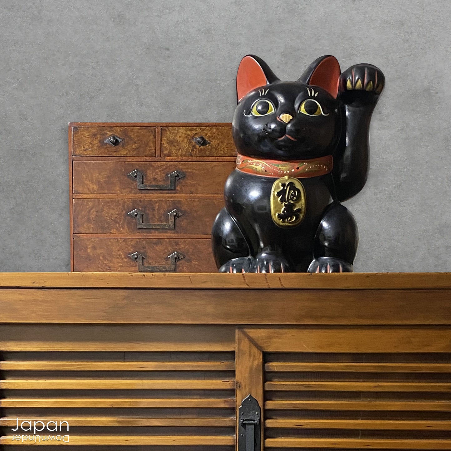 Welcome prosperity and good fortune into your space with this impressive oversized black antique Japanese lucky cat. Its charm is undeniable, from the adorable face to the beckoning paw, symbolizing wealth and good luck. A unique addition to your decor,  the maneki neko cat will certainly bring a smile to your face. Perfect for cat lovers and anyone seeking a touch of luck in their lives.