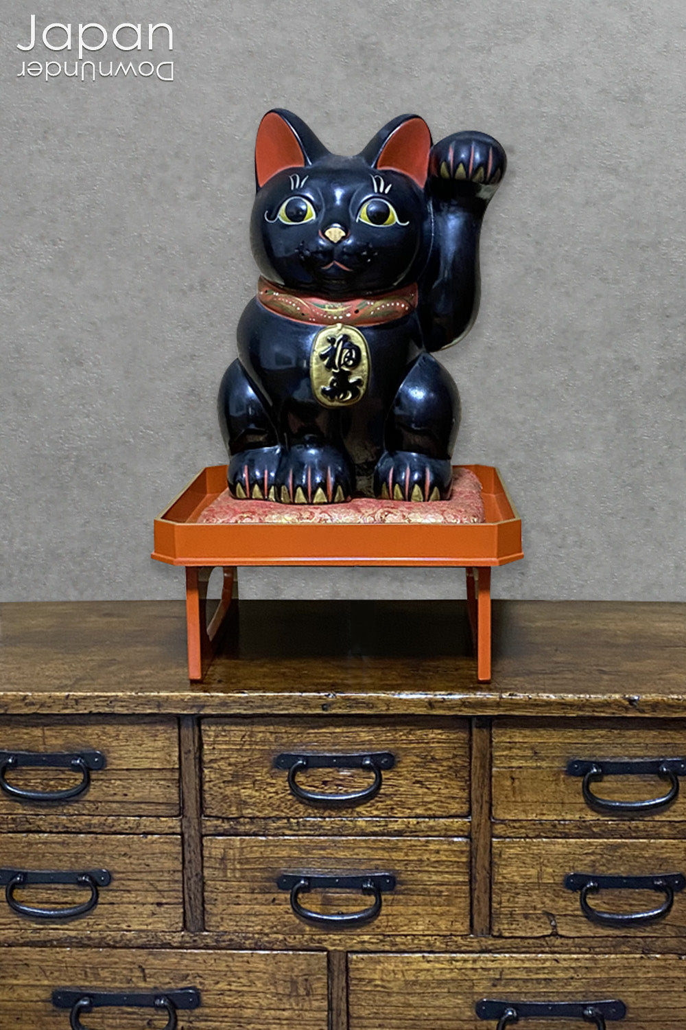 Welcome prosperity and good fortune into your space with this impressive oversized black antique Japanese lucky cat. Its charm is undeniable, from the adorable face to the beckoning paw, symbolizing wealth and good luck. A unique addition to your decor,  the maneki neko cat will certainly bring a smile to your face. Perfect for cat lovers and anyone seeking a touch of luck in their lives.