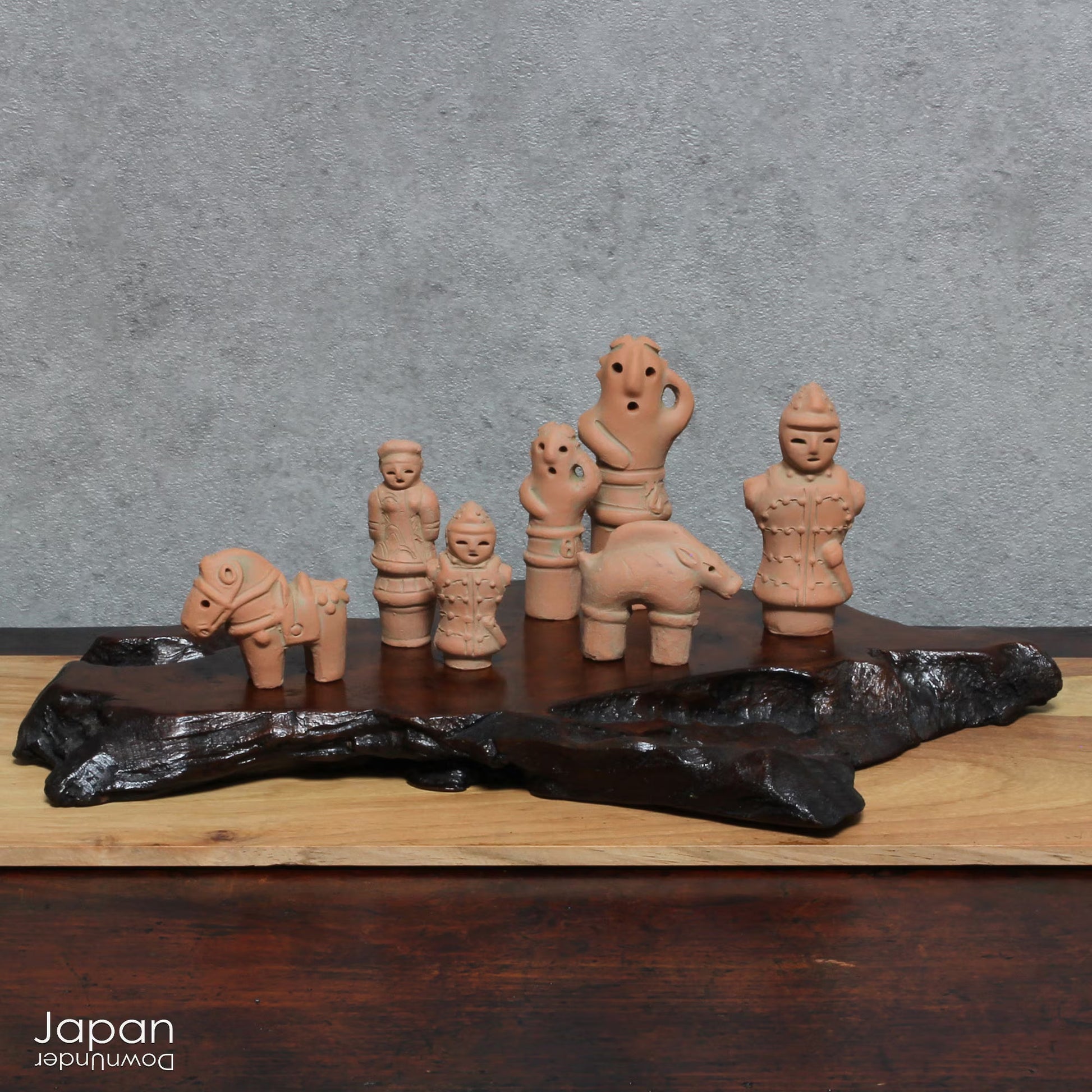 Discover a unique and charming collection of miniature Japanese funerary figures - haniwa - in this one-of-a-kind set. Each tiny piece is delicately handcrafted from terracotta, showcasing remarkable detail and traditional craftsmanship. Perfect for collectors or anyone with a love for Japanese history and art, these figures add a touch of quiet elegance to any decor.