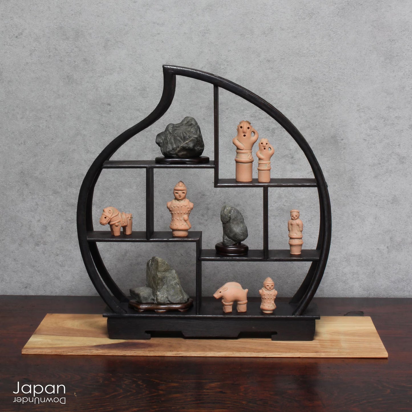 Discover a unique and charming collection of miniature Japanese funerary figures - haniwa - in this one-of-a-kind set. Each tiny piece is delicately handcrafted from terracotta, showcasing remarkable detail and traditional craftsmanship. Perfect for collectors or anyone with a love for Japanese history and art, these figures add a touch of quiet elegance to any decor.