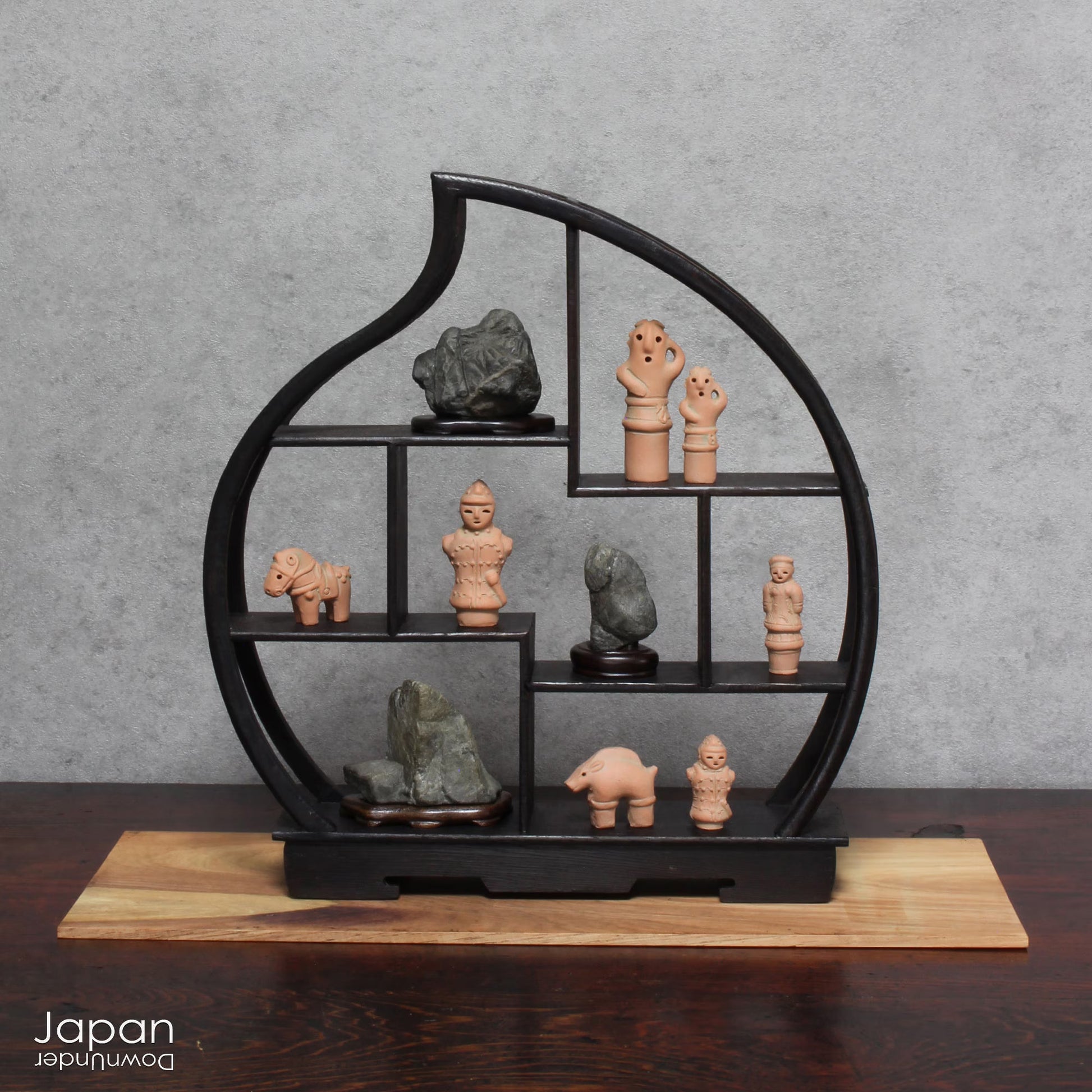 Discover a unique and charming collection of miniature Japanese funerary figures - haniwa - in this one-of-a-kind set. Each tiny piece is delicately handcrafted from terracotta, showcasing remarkable detail and traditional craftsmanship. Perfect for collectors or anyone with a love for Japanese history and art, these figures add a touch of quiet elegance to any decor.