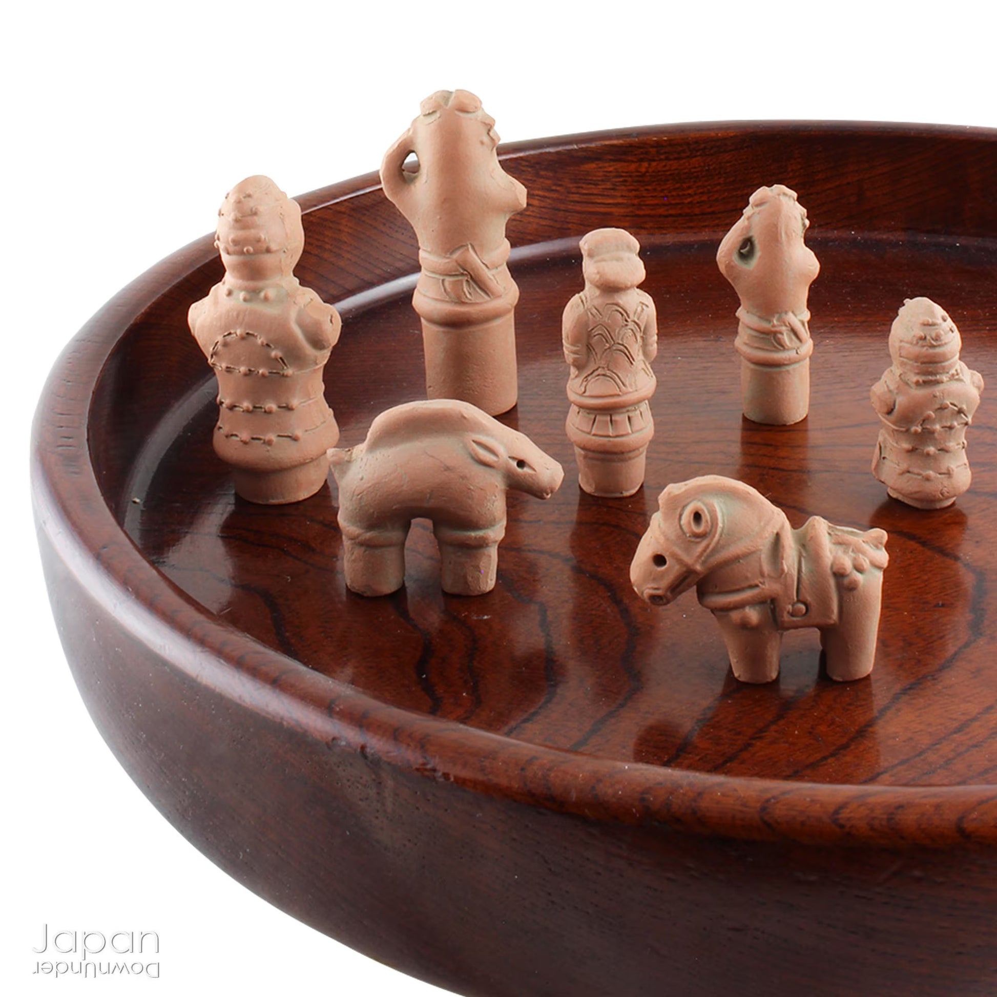 Discover a unique and charming collection of miniature Japanese funerary figures - haniwa - in this one-of-a-kind set. Each tiny piece is delicately handcrafted from terracotta, showcasing remarkable detail and traditional craftsmanship. Perfect for collectors or anyone with a love for Japanese history and art, these figures add a touch of quiet elegance to any decor.