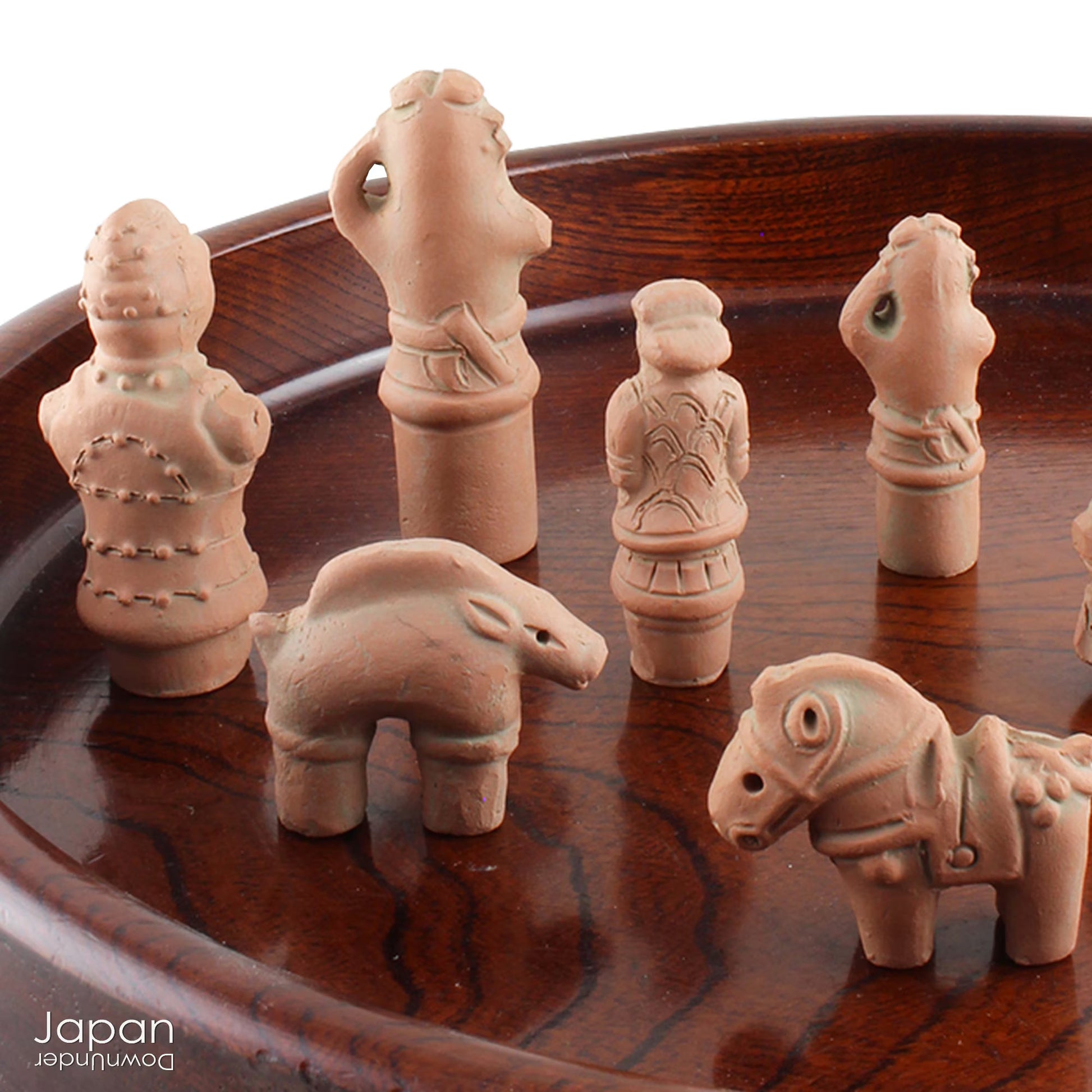 Discover a unique and charming collection of miniature Japanese funerary figures - haniwa - in this one-of-a-kind set. Each tiny piece is delicately handcrafted from terracotta, showcasing remarkable detail and traditional craftsmanship. Perfect for collectors or anyone with a love for Japanese history and art, these figures add a touch of quiet elegance to any decor.
