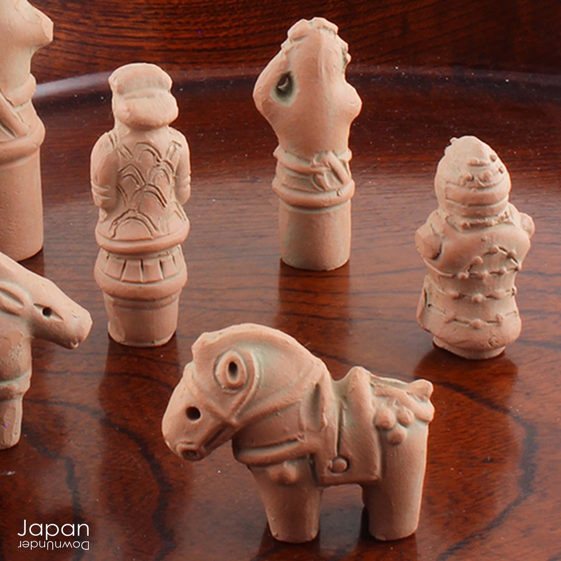 Discover a unique and charming collection of miniature Japanese funerary figures - haniwa - in this one-of-a-kind set. Each tiny piece is delicately handcrafted from terracotta, showcasing remarkable detail and traditional craftsmanship. Perfect for collectors or anyone with a love for Japanese history and art, these figures add a touch of quiet elegance to any decor.