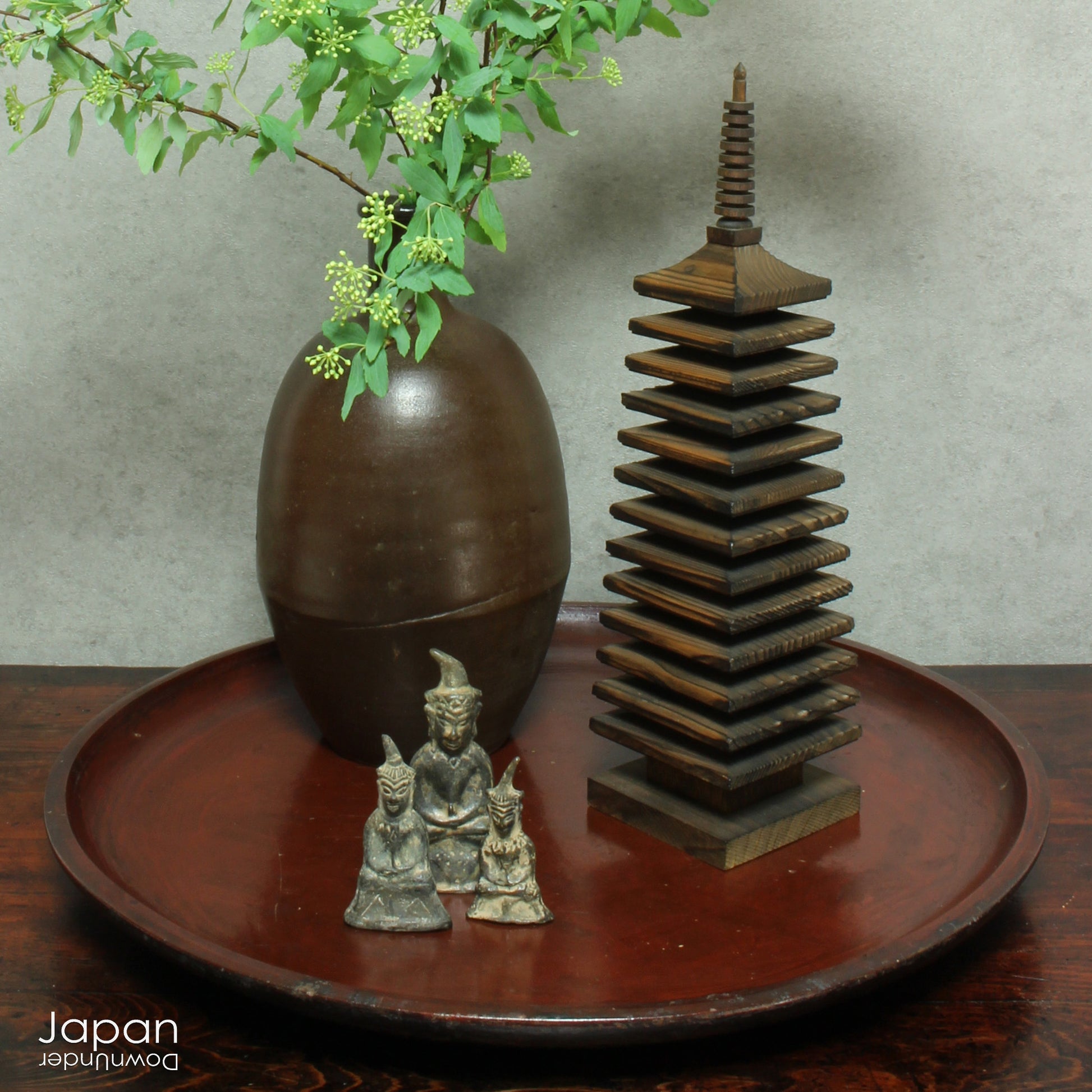 A stunning 1800’s Japanese folk art round serving tray. This versatile piece doubles as a unique display stand adding a touch of rustic charm to any decor. The beautiful dark wine red and black color palette showcases the wonderful patina of use, making it a truly one-of-a-kind art object.