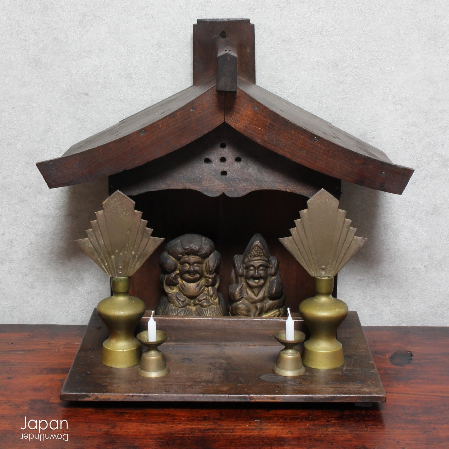 A perfect addition to your spiritual space, this quaint rustic antique Shinto shrine, made to be placed on the kamidana (god shelf), houses the lucky god Ebisu and Daikoku. The charming hand crafted god house embodies the essence of Shinto folk faith