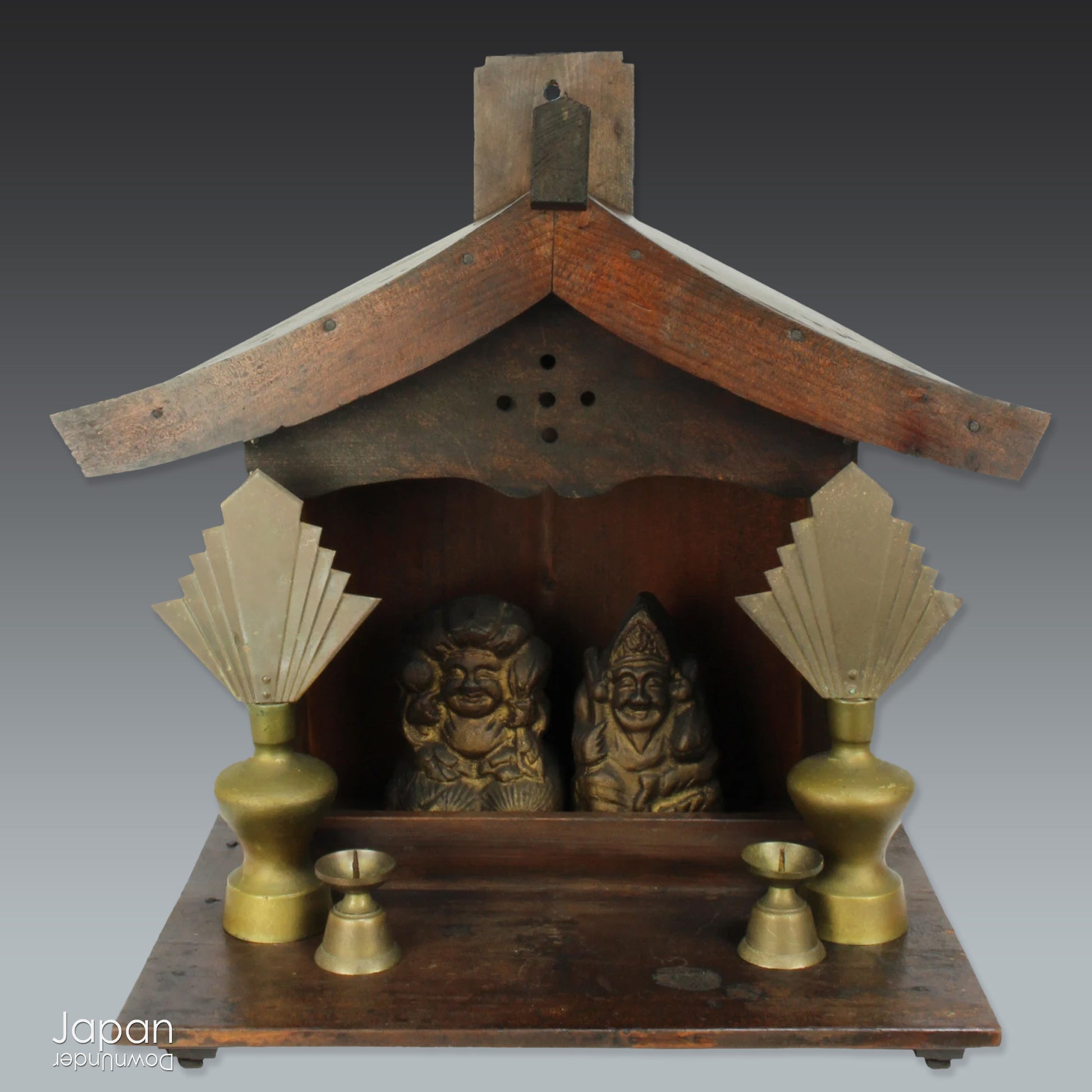 A perfect addition to your spiritual space, this quaint rustic antique Shinto shrine, made to be placed on the kamidana (god shelf), houses the lucky god Ebisu and Daikoku. The charming hand crafted god house embodies the essence of Shinto folk faith.