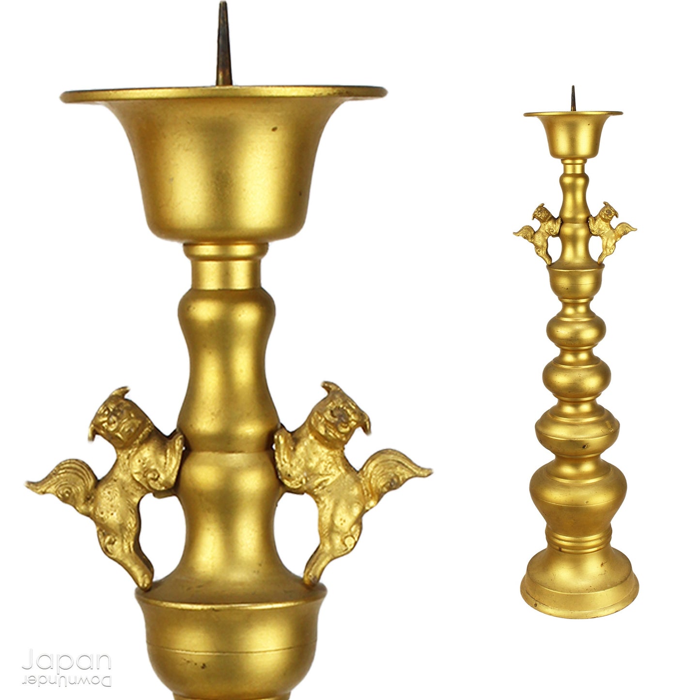 An antique Buddhist temple candle holder.    The gilded brass candle holder is a cylindrical shape, formed of spheres,  gradually decreasing in size as they move upwards. Just below the candle cup hang a pair of Japanese komainu, or lion dogs.